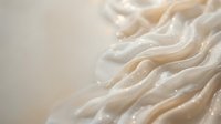 Fresh homemade pasta noodles with flour dusting on neutral background. Artisanal Italian cuisine preparation for cooking and culinary projects.