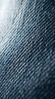 Close-up of blue denim fabric texture showing woven cotton weave pattern, suitable for fashion, textile, and apparel design projects.