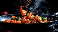 Sizzling shrimp in black pan with aromatic steam, spices and herbs against dark background. Dramatic food photography with flying seasonings and smoke.