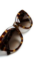 Pair of tortoiseshell acetate sunglasses with round frames and dark lenses, displayed on white background for fashion, eyewear retail, and accessories marketing.