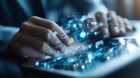 Hands typing on keyboard with futuristic digital interface overlay showing glowing blue icons and data visualization elements for technology concept.