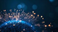 Glowing blue and orange light particles emanating from curved surface with bokeh effect against dark background, creating magical cosmic atmosphere.