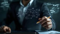 Business professional drawing digital flowchart diagram on virtual screen, demonstrating strategic planning and process optimization in dark office setting.