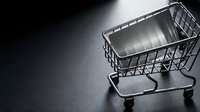 Empty shopping cart on dark surface, retail and commerce concept for online shopping, sales, and e-commerce design projects.