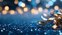 Golden curled ribbon on blue glitter surface with soft bokeh lights in background, creating festive holiday atmosphere for celebration designs.