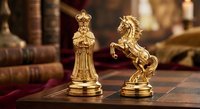 Golden chess pieces king and knight on wooden board with vintage books in background for strategic business planning and leadership concepts.