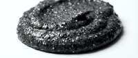 Crackled charcoal cookie with sparkly sugar coating on white background, isolated baked good for food photography and culinary design projects.