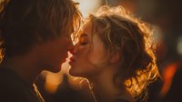 Young couple sharing intimate kiss in warm golden light creating romantic atmosphere for love and relationship concepts.