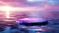 Dramatic water drop ripple at sunset creating circular patterns on reflective surface with purple and pink sky colors merging into tranquil aquatic scene.