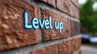 Level up graffiti text on brick wall with shallow depth of field, modern urban street art in bright blue neon style against textured brown background.
