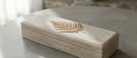 Wooden tissue box with laser engraved fern leaf design on natural wood surface. Modern minimalist home decor accessory for contemporary interior styling.
