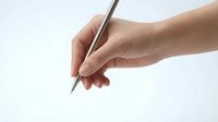 Hand holding silver pen ready to write on white paper background for business documents and creative writing projects.