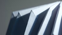 Abstract white paper geometric shapes creating sharp angular shadows and highlights in minimalist composition for modern design projects.