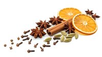 Aromatic winter spices with dried orange slices, cinnamon sticks, star anise, cardamom and cloves isolated on white background for seasonal cooking.