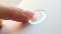 Close-up of a finger touching a contact lens on a white surface, showing lens care and eye health management for optical and medical applications.