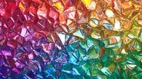 Colorful crystal fragments in rainbow gradient from pink to green, creating abstract mosaic pattern with light reflections and geometric shapes. Artistic background design.