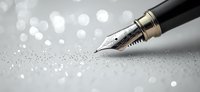 Elegant fountain pen nib on light gray surface with sparkling bokeh effect background creating dreamy atmosphere for writing and creativity concepts.