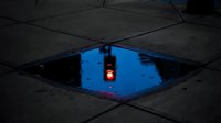 Red traffic light reflected in urban puddle surrounded by dark wet pavement and geometric tile patterns, creating mirror effect for urban photography and street scene concepts.
