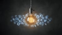 Glowing lightbulb with floating digital icons representing innovation, technology and creative ideas for business solutions and brainstorming concepts.