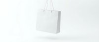 White paper shopping bag with handles floating on clean minimalist background for retail branding and commercial design projects.