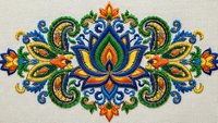 Ornate embroidered paisley motif with colorful floral elements and decorative swirls on fabric background for textile design and craft projects.