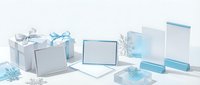 Elegant winter holiday gift boxes and blank cards in soft blue and white tones with decorative snowflakes on clean background for seasonal marketing.