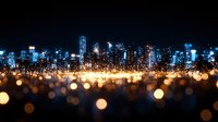 Modern cityscape at night with glowing bokeh lights in foreground creating magical urban atmosphere, skyscrapers silhouettes against dark sky illuminate downtown panorama.