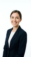 Professional young Caucasian businesswoman in navy blazer smiling confidently on white background isolated for corporate design use.