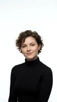 Professional young woman with curly brown hair wearing black turtleneck sweater smiling confidently on white background isolated for business design.