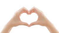 Female hands forming heart shape gesture on white background isolated for love romance and affection concepts in healthcare wellness and relationship designs.
