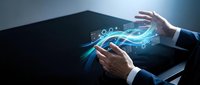 Businessman hands holding tablet with glowing digital wave and data stream flowing across screen, representing technology innovation and digital transformation for business solutions.