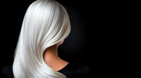 Platinum blonde hair flowing against dark background showcases smooth, silky texture and professional haircut styling for beauty and fashion industry use.