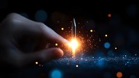 Hand holding glowing light sword with magical sparkles and bokeh effects against dark background, creating mystical atmosphere for fantasy and creative designs.