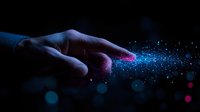 Magical finger touch creating glowing blue and pink sparkle trail effect against dark background, mystical energy concept for spiritual and fantasy designs.