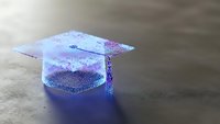 Holographic graduation cap with glittery surface reflecting purple and blue light on dark background for education celebration concepts.