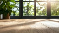 Sunlit wooden floor with natural grain texture near window, green plants and morning light creating warm atmosphere for interior design and home decor projects.