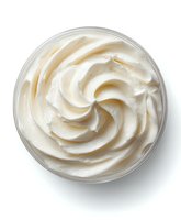Creamy white moisturizing face cream with swirled texture in glass jar isolated on white background for skincare and beauty product design.