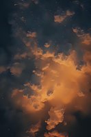 Dramatic orange and dark blue storm clouds illuminated at sunset with scattered stars visible through breaks in cloudy evening sky.