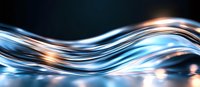 Abstract flowing light waves in blue and orange colors against dark background create dynamic motion effect for modern technology and business designs.