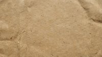 Natural brown sand texture with fine grains and subtle ripple patterns creating organic surface for backgrounds and design projects.