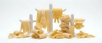 Assorted dried pasta shapes including fettuccine, penne, fusilli and farfalle arranged on white background for cooking, recipe and food preparation projects.