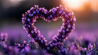 Purple wildflowers form heart shape against blurred sunset background, creating romantic natural composition with soft bokeh effect and dreamy atmosphere.