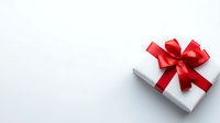 White gift box with elegant red satin bow and ribbon on light background with copy space for holiday greeting cards and festive designs.