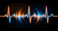 Digital heartbeat pulse with glowing orange and blue light trails on black background for medical technology presentations and healthcare designs.