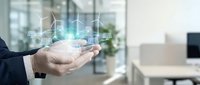 Businessman holding digital hologram of smart home technology with connected devices and automation icons in modern office environment.