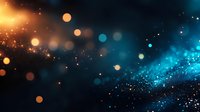 Magical glowing particles with orange and blue bokeh lights on dark background create dreamy cosmic atmosphere. Abstract defocused sparkles float in space.