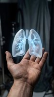 Male hand holding glowing translucent lungs with bronchial tree visualization against dark background. Medical education, healthcare, respiratory system anatomy, pulmonology concept.
