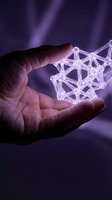 Hand holding glowing geometric network structure with connected nodes and lines representing digital connectivity and data visualization on purple background.
