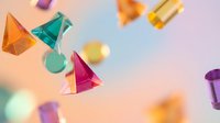 Colorful transparent geometric shapes floating in the air on a soft pastel background, creating a vibrant and dynamic composition.