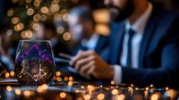 Glowing wine glass with financial chart reflection against blurred business meeting background with bokeh lights and evening atmosphere.